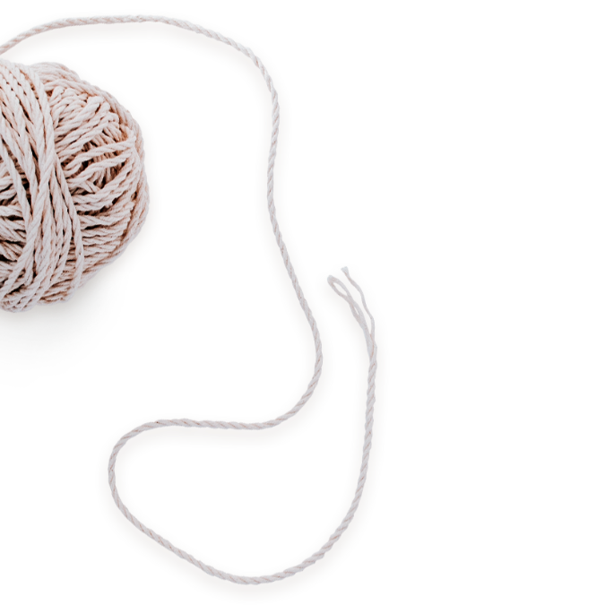 A ball of light-colored yarn with a long, loose strand extending outward, set against a plain background—an image evoking the unraveling and connection found in mental health workshops.